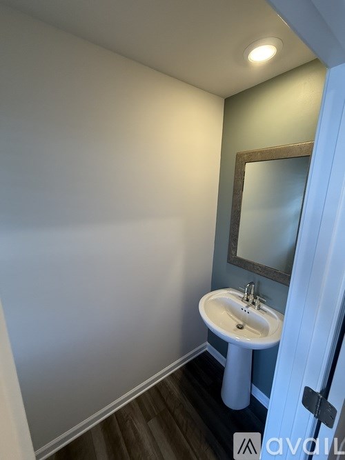 A white sink in a small bathroom.