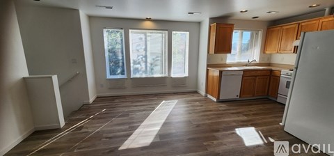 A kitchen with wooden cabinets and a refrigerator.