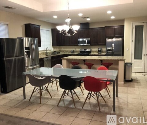 A kitchen with a glass table and chairs.