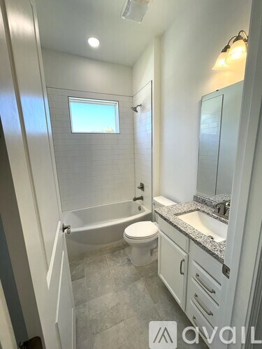 A bathroom with a toilet, sink, and shower.
