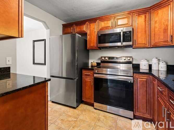 A kitchen with wooden cabinets and stainless steel appliances.