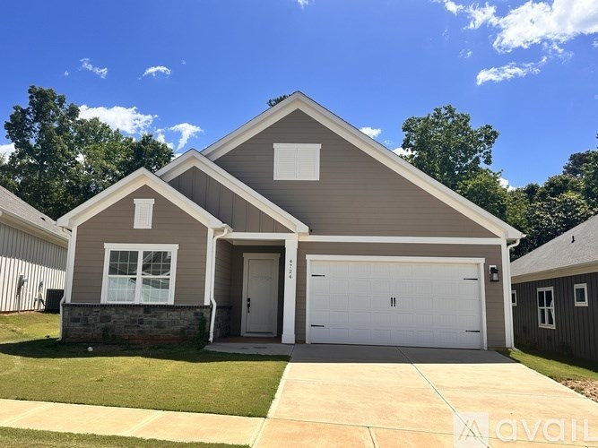 A two-story house with a garage and a driveway.