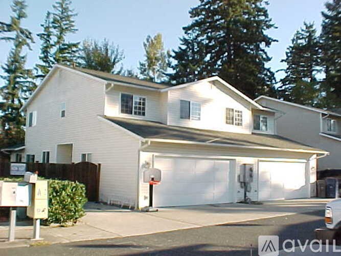 A two-story house with a garage is for sale.