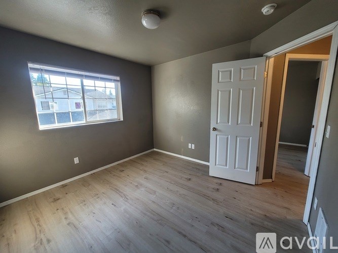 A room with a white door and a window.