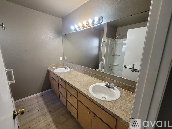 A bathroom with a sink, mirror, and light fixture.