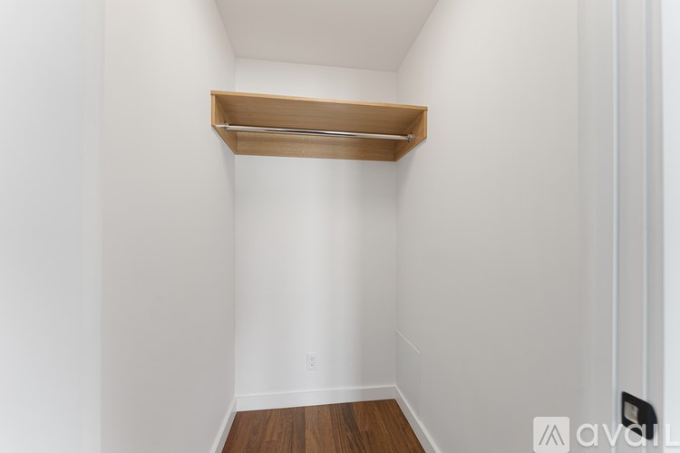 A white wall with a wooden shelf on top.