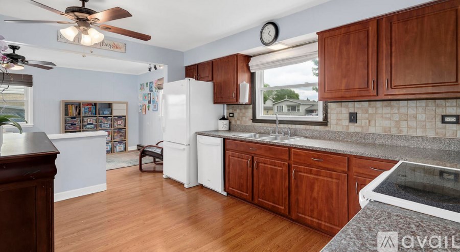 A kitchen with wooden cabinets and a white refrigerator.