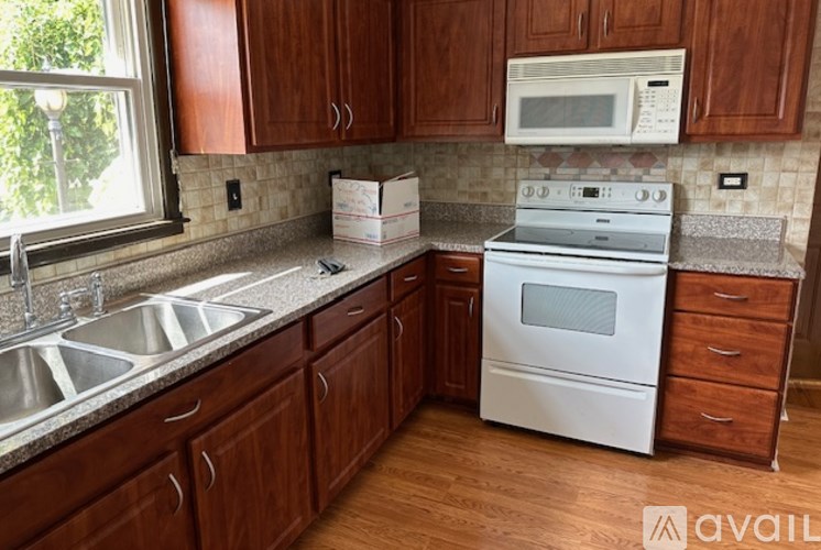 A kitchen with wooden cabinets and a white oven.
