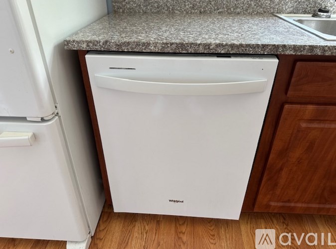 A white dishwasher is placed in a kitchen.