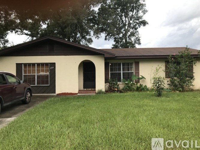 A house with a car parked in front of it.
