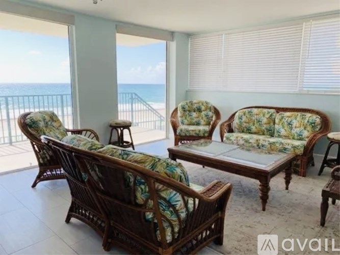 A living room with a view of the ocean.