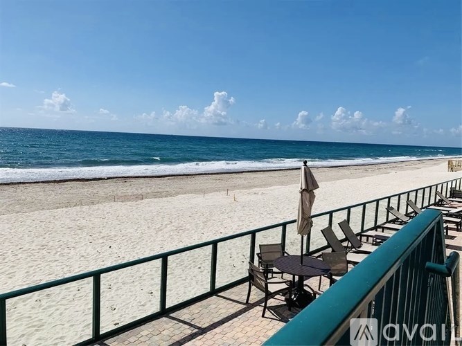 A beach scene with a clear sky and ocean.