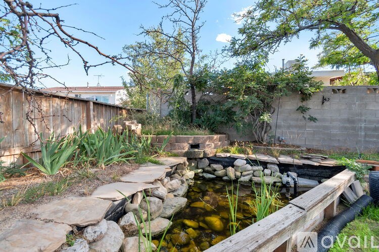A spacious room with a fireplace and wood flooring.