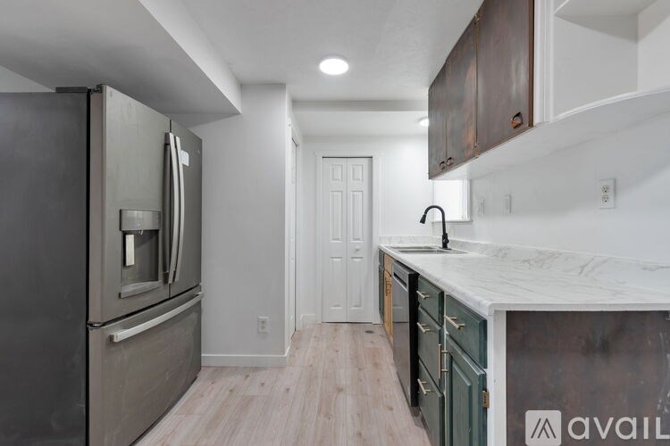 A room with wooden flooring and a window.