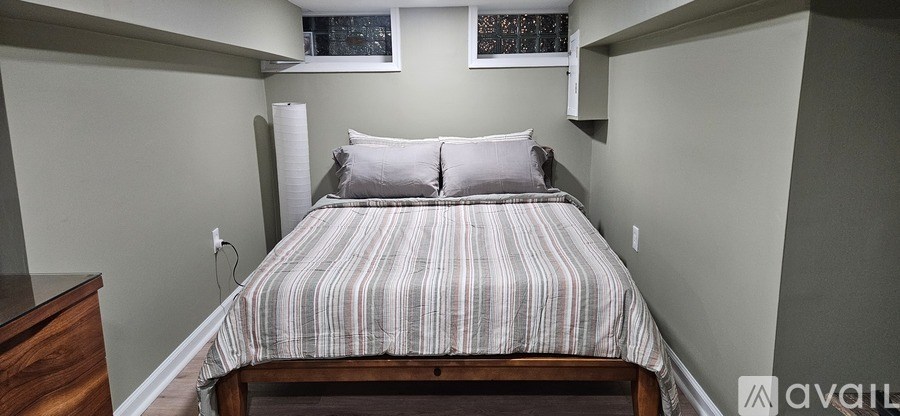A bathroom with a toilet, sink, and mirror.