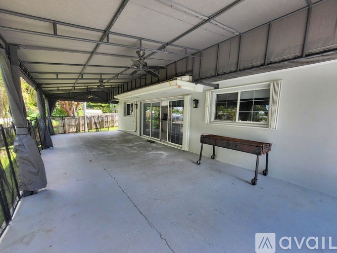 A patio area with a bench and a fan.