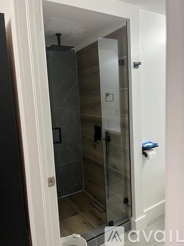 A bathroom with a toilet, sink, and mirror.