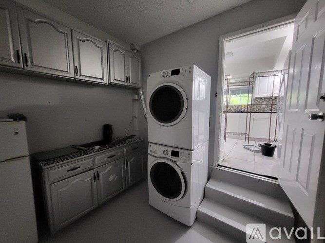 A laundry room with a washer and dryer stacked on top of each other.