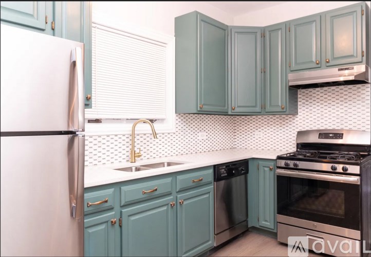 A kitchen with a white fridge and blue cabinets.