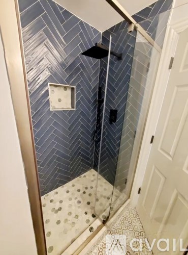 A bathroom with a shower and a tiled floor.