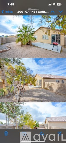 A yellow house with a red grill in the backyard.