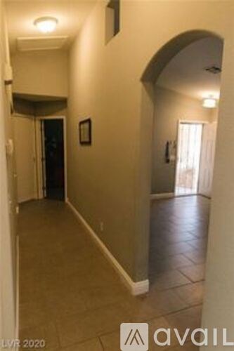 A hallway with a door on the left and a window on the right.