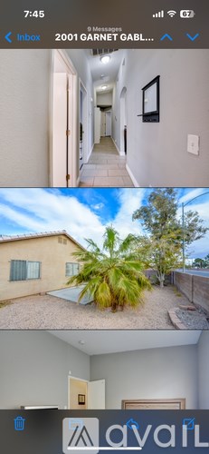 A long hallway with doors on both sides and a picture on the wall.