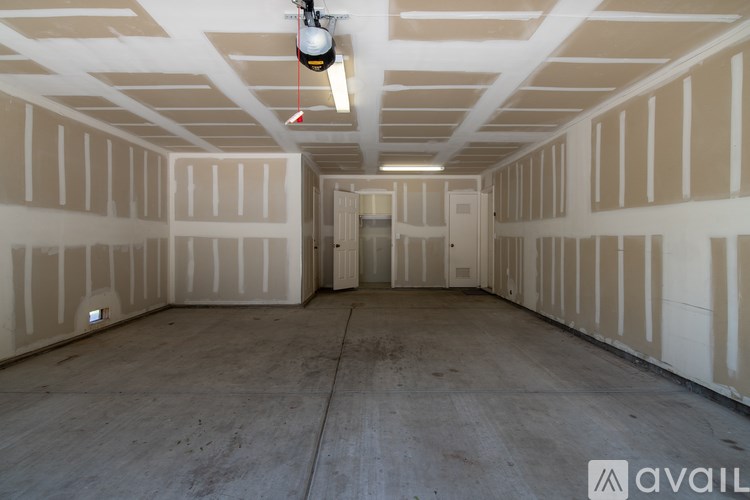 A room with a concrete floor and walls covered in insulation.