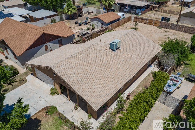 A house with a brown roof and a driveway.