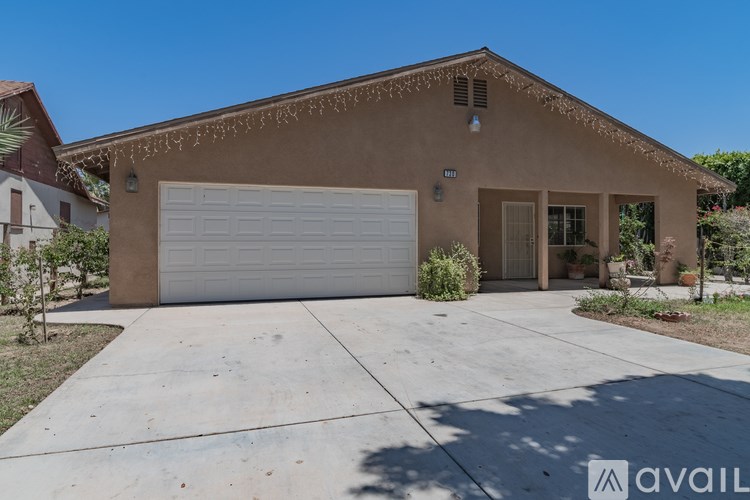 A house with a garage door and a driveway in front.