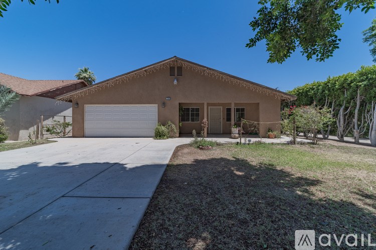 A house with a garage and driveway is available for sale.