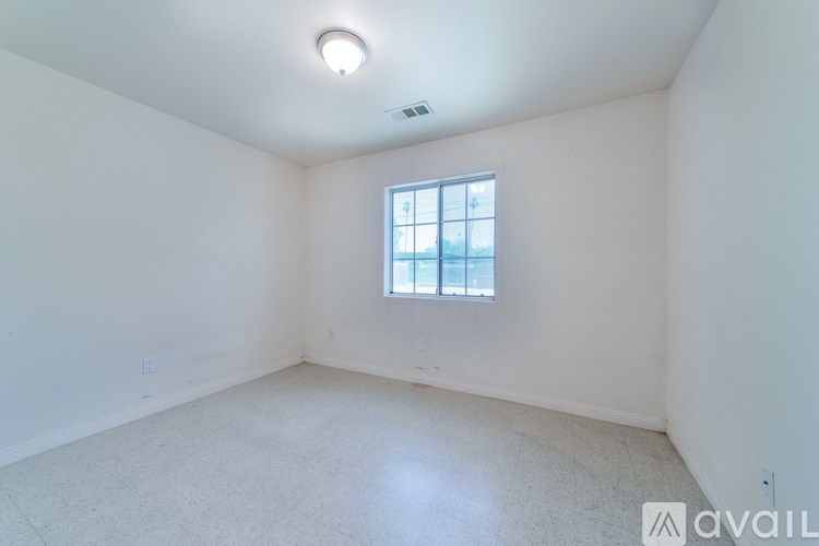 A room with a window and a ceiling light.