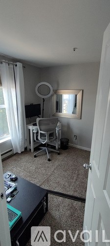 A room with a desk and a chair.