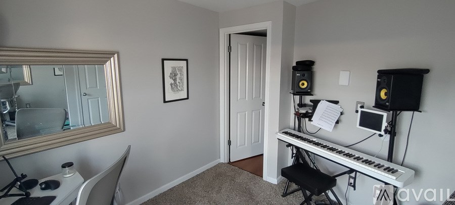 A room with a piano and a mirror on the wall.