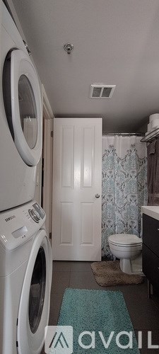 A small laundry room with a washer and dryer.