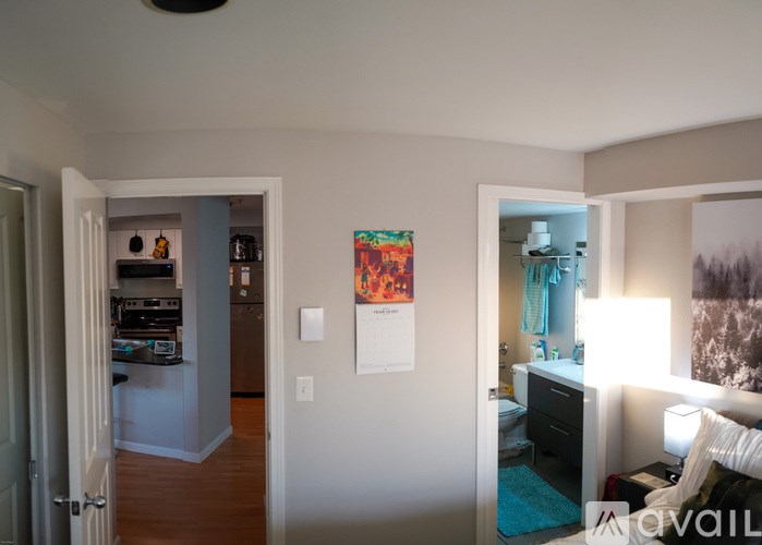 A room with a bed, a dresser, and a painting on the wall.