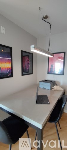 A table with a laptop and a box on it.