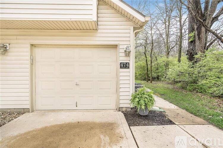 A white garage door with the number 474 on it.