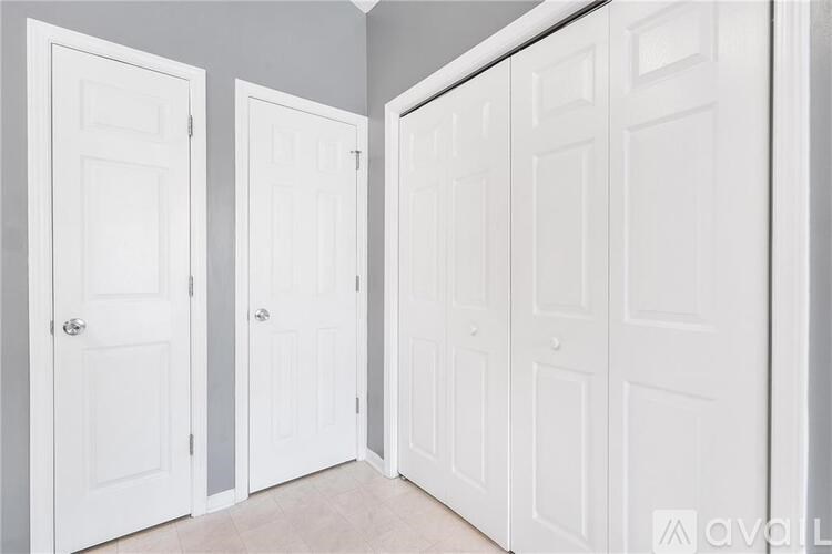 A hallway with three white doors.