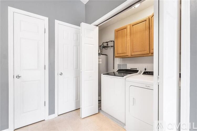 A small laundry room with a washer and dryer.