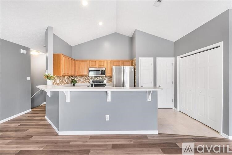 A kitchen with wooden cabinets and a white countertop.