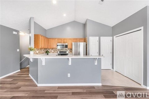 A kitchen with wooden cabinets and a white countertop.