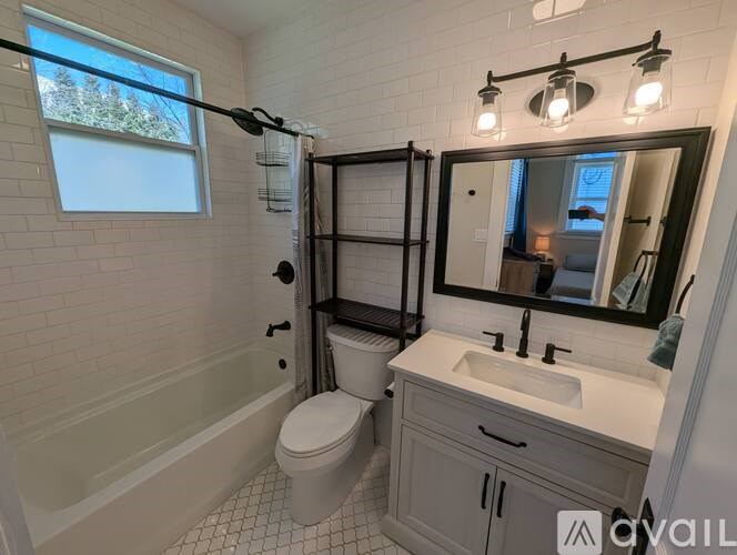 A bathroom with a toilet, sink, and a window.