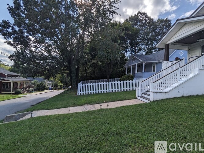 A white picket fence in front of a house.