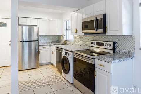 A kitchen with a stainless steel refrigerator and a white oven.