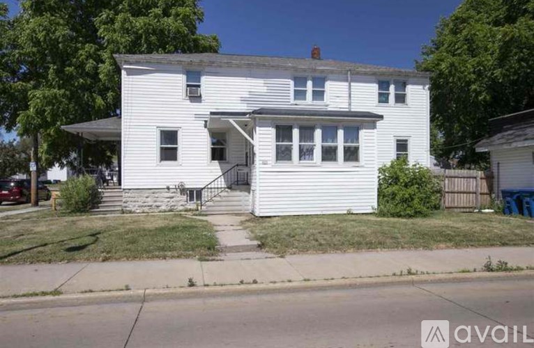 A white two-story house with a front porch.