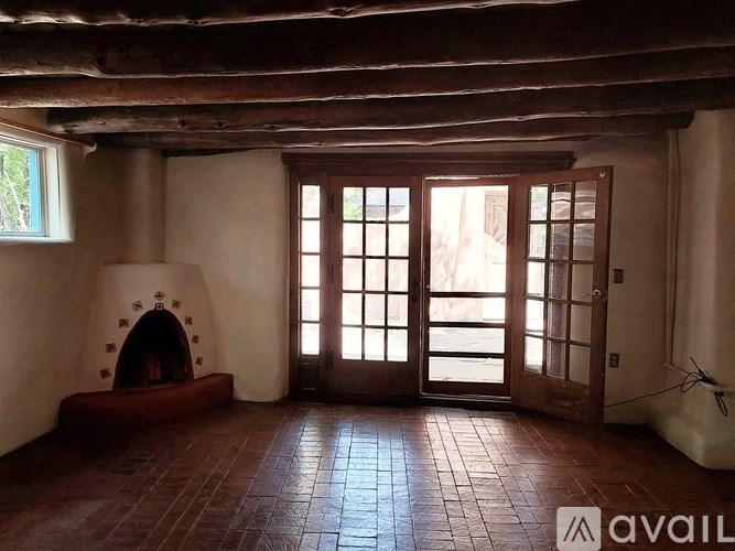 A room with a fireplace and tiled flooring.