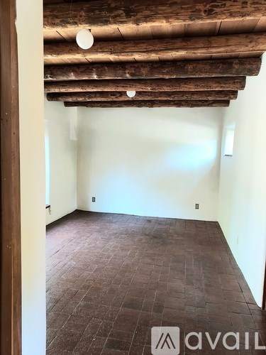 A room with a wooden ceiling and floor.