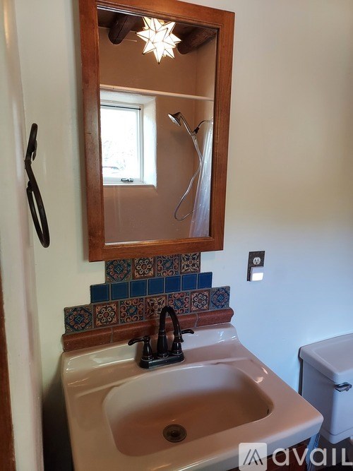 A bathroom with a sink and mirror.