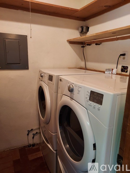 Two front loading washing machines in a laundry room.